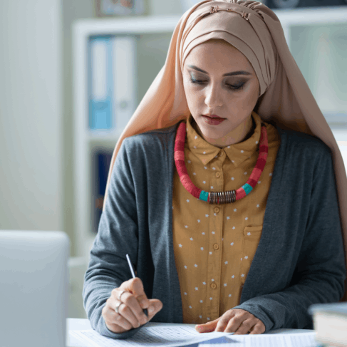 A translator compares Arabic and English pages as Arabic Translation Services in Iowa refine academic document wording.