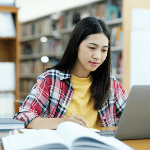 A student submits transcripts online while Vietnamese Translation Services prepare an academic translation for school review.