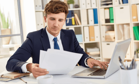 A translator delivers accurate Translation Services in West Des Moines by proofreading a formatted report on a desktop.