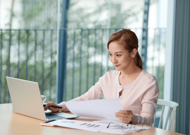 A client reviews a certified birth certificate as Vietnamese Translation Services prepare an official packet for filing.