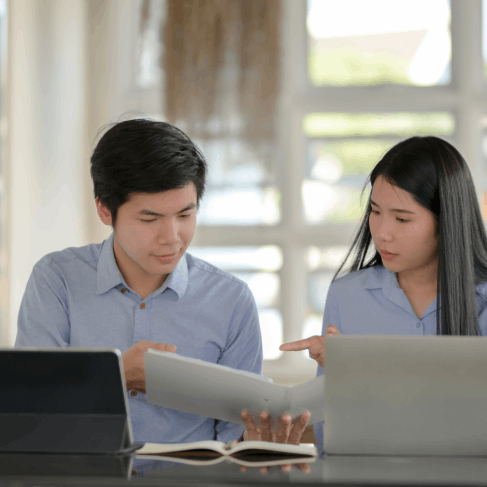 A manager reviews a bilingual contract as Chinese Translation Services in Iowa deliver certified business translations.