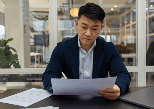 A native translator edits a birth certificate as Chinese Translation Services in Iowa provide high-quality English.
