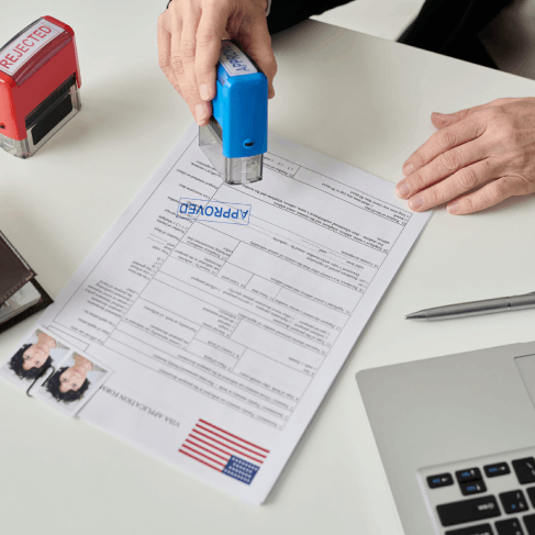 A translator stamps and signs a USCIS certified translation packet as Translation Services in Des Moines finalizes.