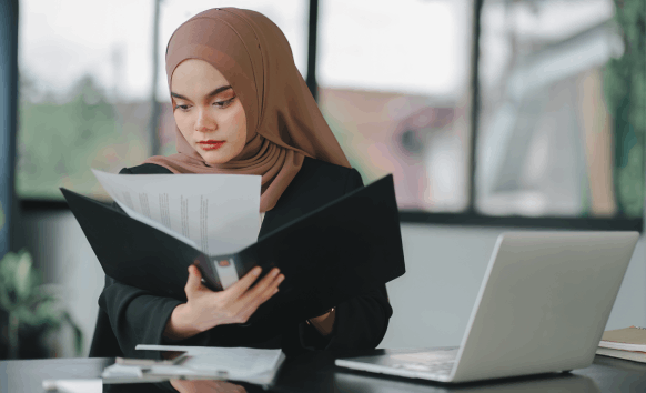 An ATA-certified native linguist checks a translated contract, delivering Arabic Translation Services in Iowa with a seal.
