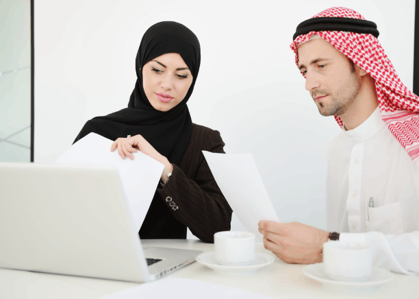 Project leads check Arabic schematics on a laptop as Arabic Translation Services in Iowa support business technical files.