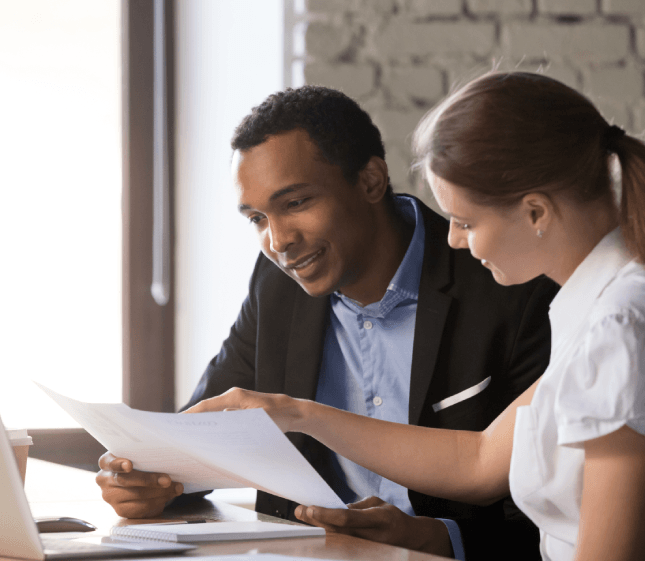 A translator compares two versions of a letter as Translation Services in Ankeny help break language barriers for a client.