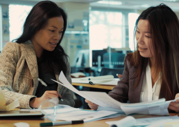 A translator compares English and Vietnamese pages on dual monitors as Vietnamese Translation Services finalize a certified.