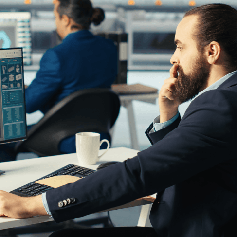 Translator works at a desk beside a CAD drawing on screen, providing Translation Services in Urbandale for technical specs.